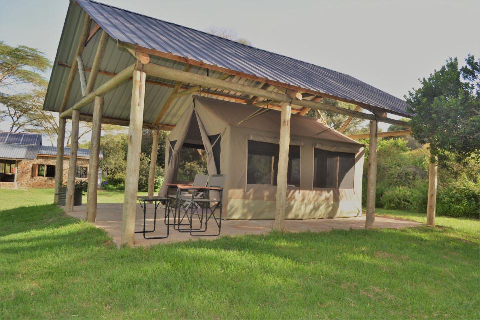 A shaded safari tent porch at Ngriki Camp.