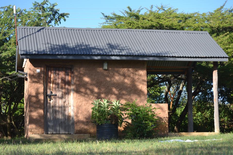 The side of a stone bathroom block at camp.