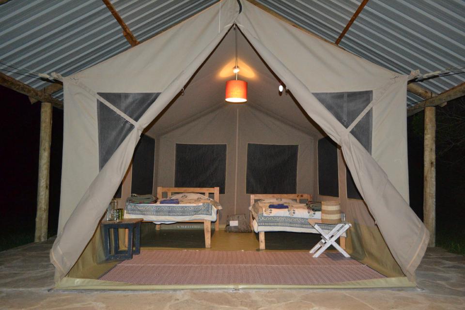 Twin beds prepared inside a safari tent at Ngriki Camp.